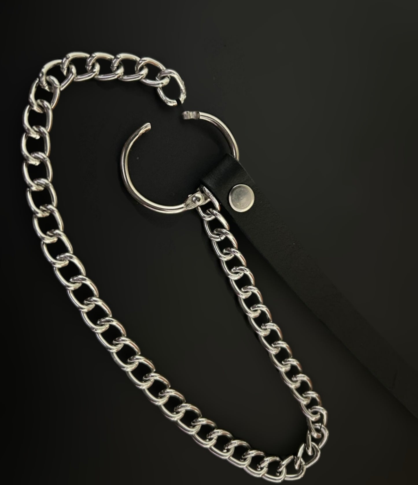 Angled flat lay of Phantom Cat grunge bracelet with black leather strap and silver chain accents — gothic alt jewelry India, styled for streetwear, rockstar, and anime cosplay aesthetics. Ideal for edgy layered looks and alt street fashion.