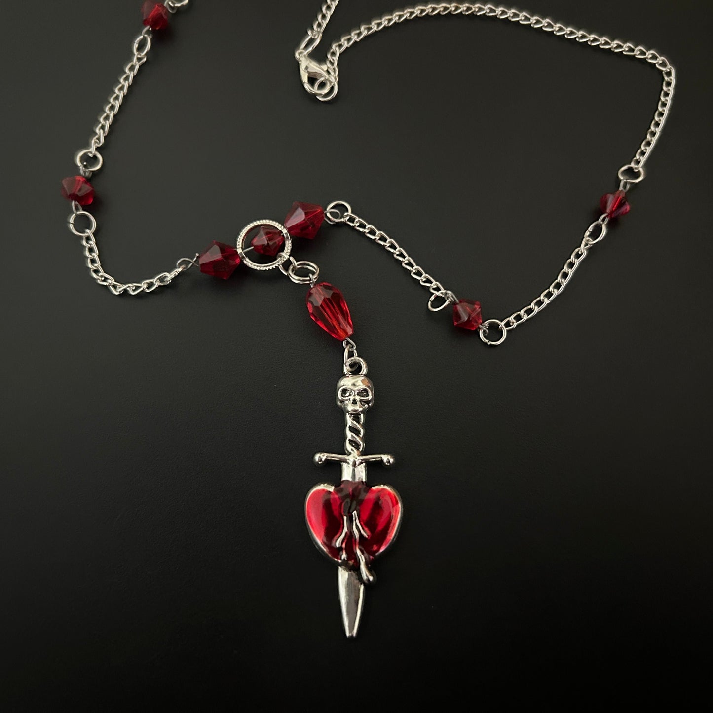 Close-up of Gothic Necklace with a Skull and Heart Motif and red crystal beads. Perfect for lovers of grunge and alt jewelry across India
