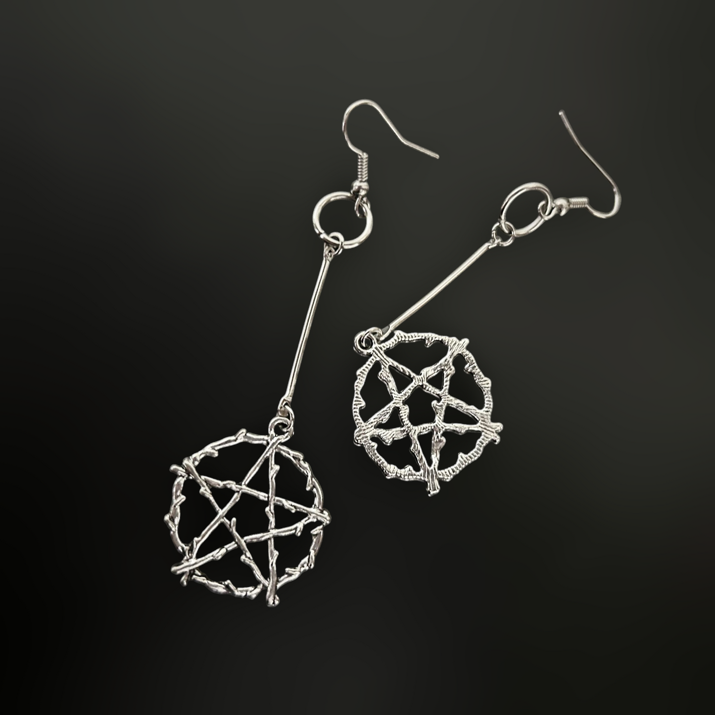 Front and back lay of pentagram star gothic earrings - sigil skeletal star charms. Daedric, occult, and dark fantasy accessories by Phantom Cat India. Skyrim-inspired