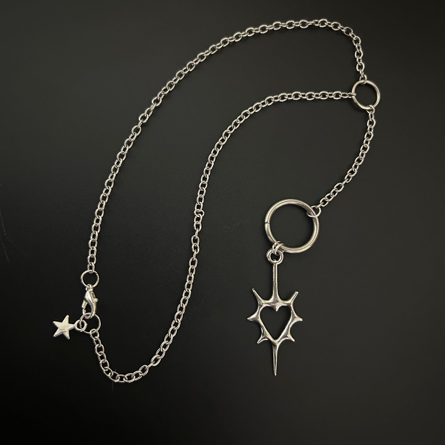 Close-up of gothic necklace with a spike heart pendant. Shop grunge fashion accessories in India - perfect for alt, street style and cosplay.