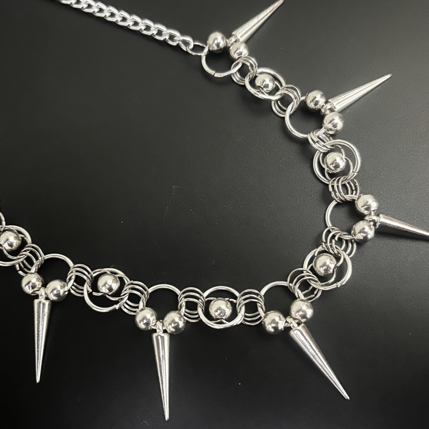 Front view of Iron Thorn Chainmaille Choker by Phantom Cat India feat. silver spikes and bead-ring clusters. Gothic and alt fashion jewelry with chainmaille construction and punk-inspired design.