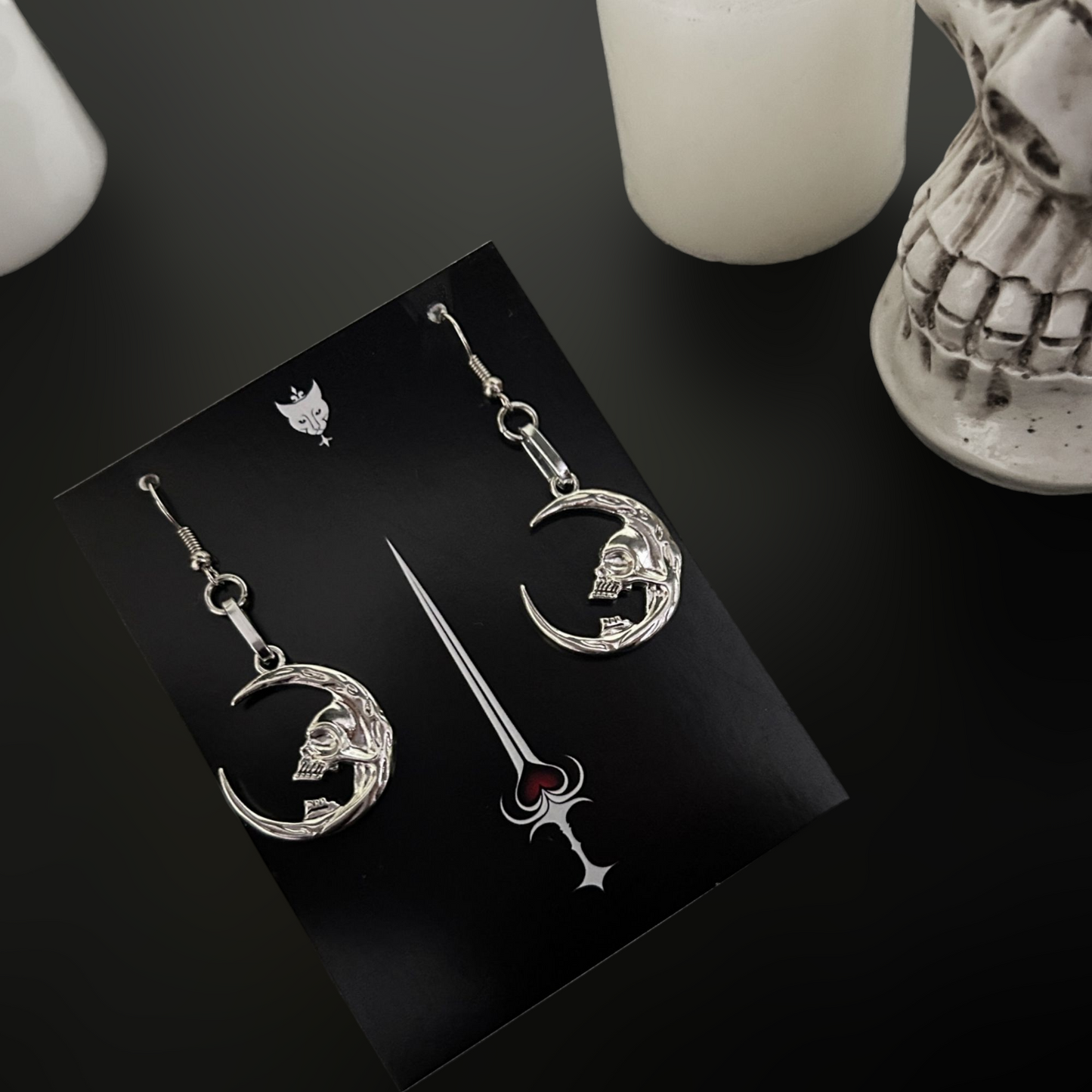 Silver moon skull earrings styled for gothic, occult, and fantasy fashion. Vampire-core jewelry for dark alt wardrobes. Shop accessories online in India.