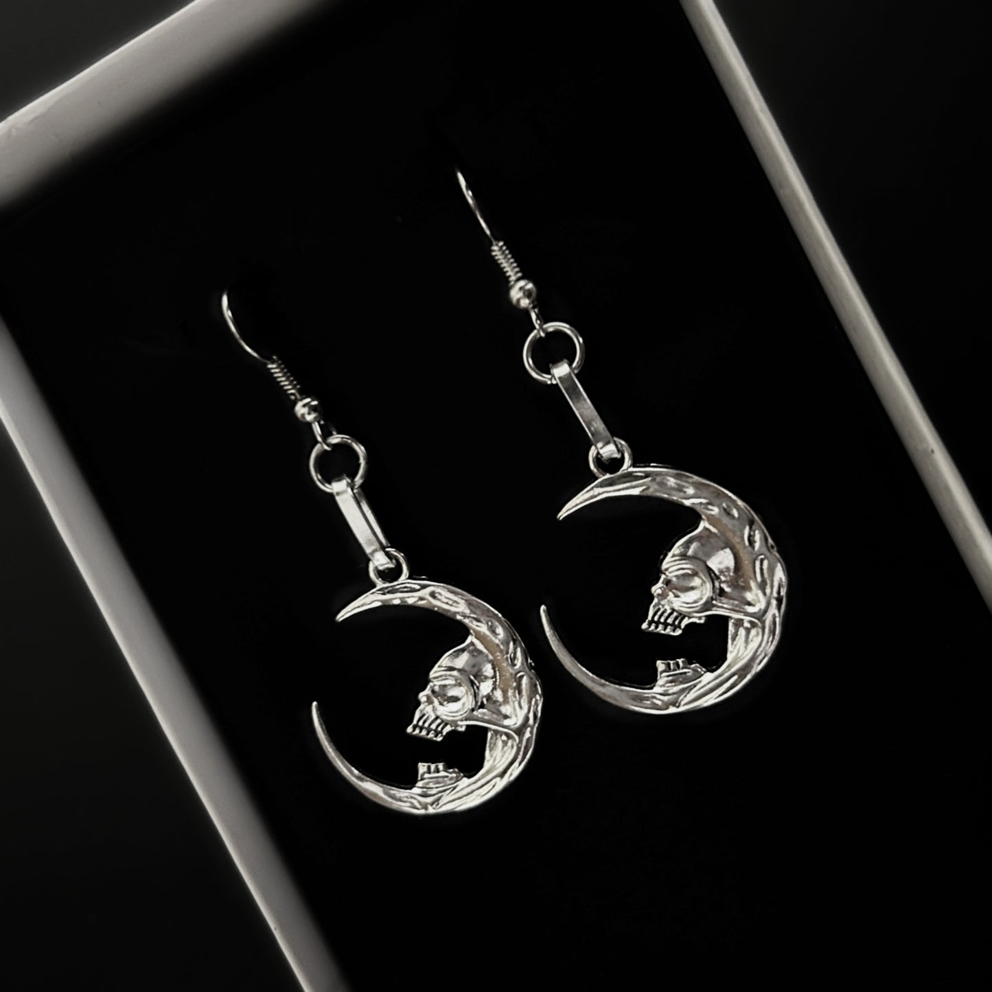 Crescent moon earrings with skull design for gothic and death-themed alt fashion. Dark fantasy jewelry by Phantom Cat. Grunge and vampire aesthetics India.