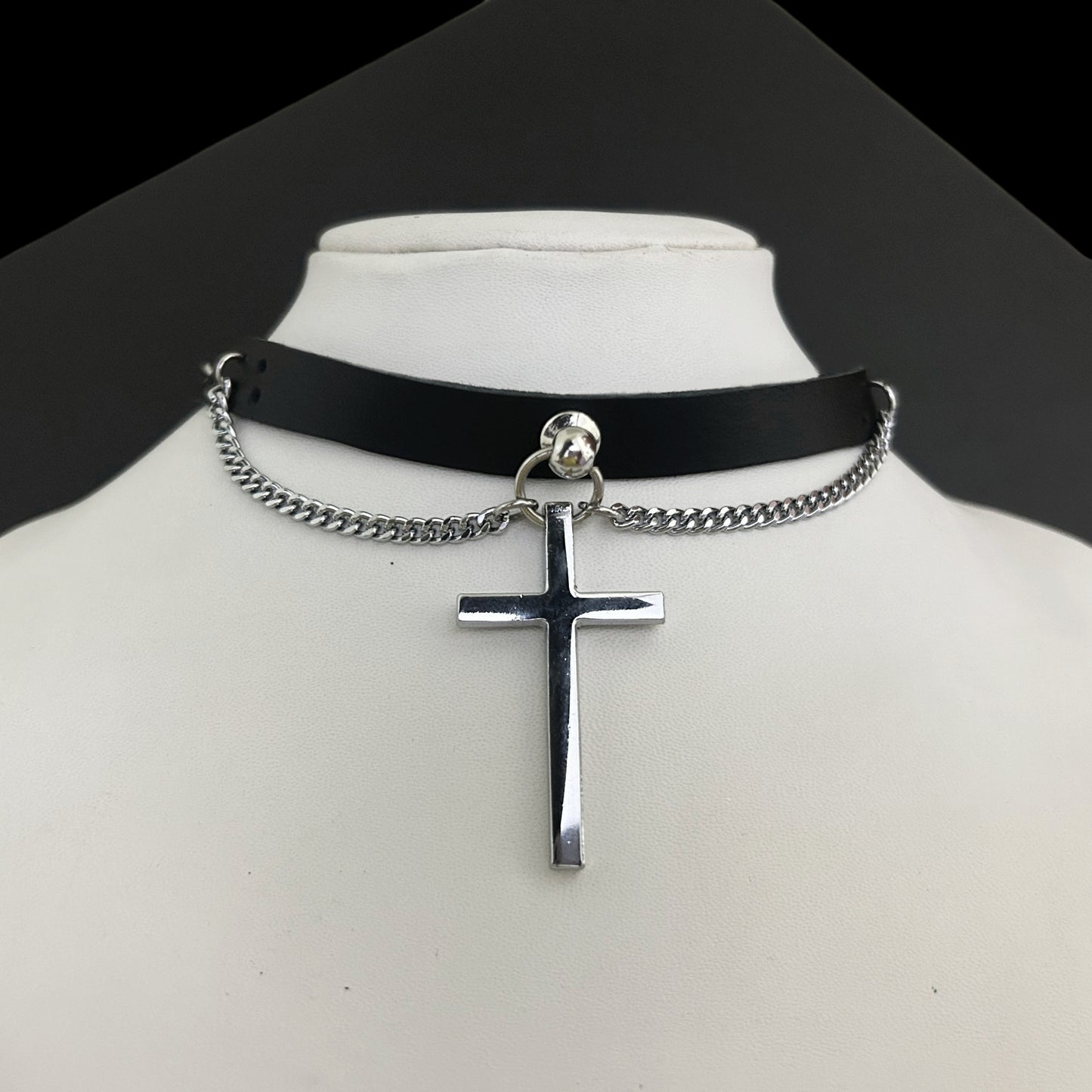 Bust display of black genuine leather gothic collar choker with stainless steel cross pendant and chain. Alt punk jewelry and accessories by Phantom Cat India.