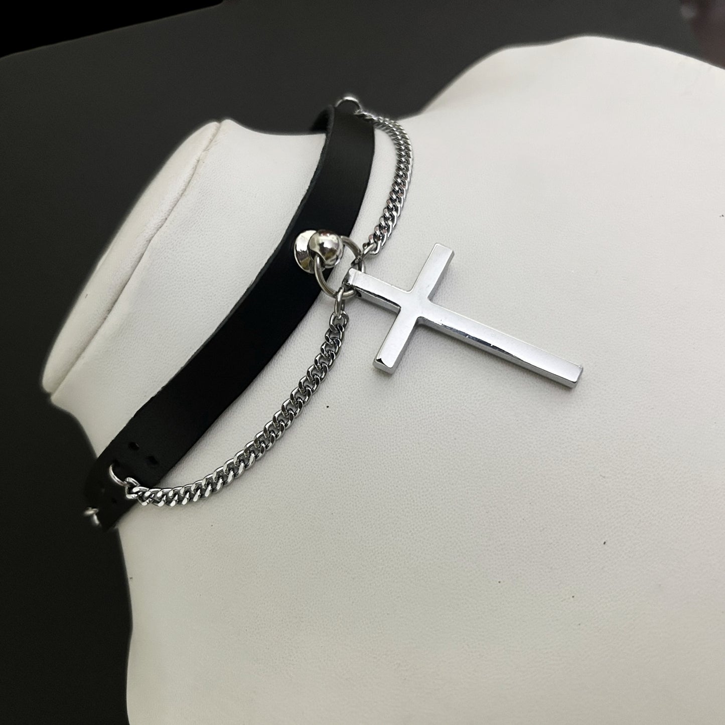 Side view - Saint & Sinner Collar feat. stainless steel crucifix and curved chain on black natural leather choker. Affordable gothic alt accessories for y2k and cosplay lovers across India