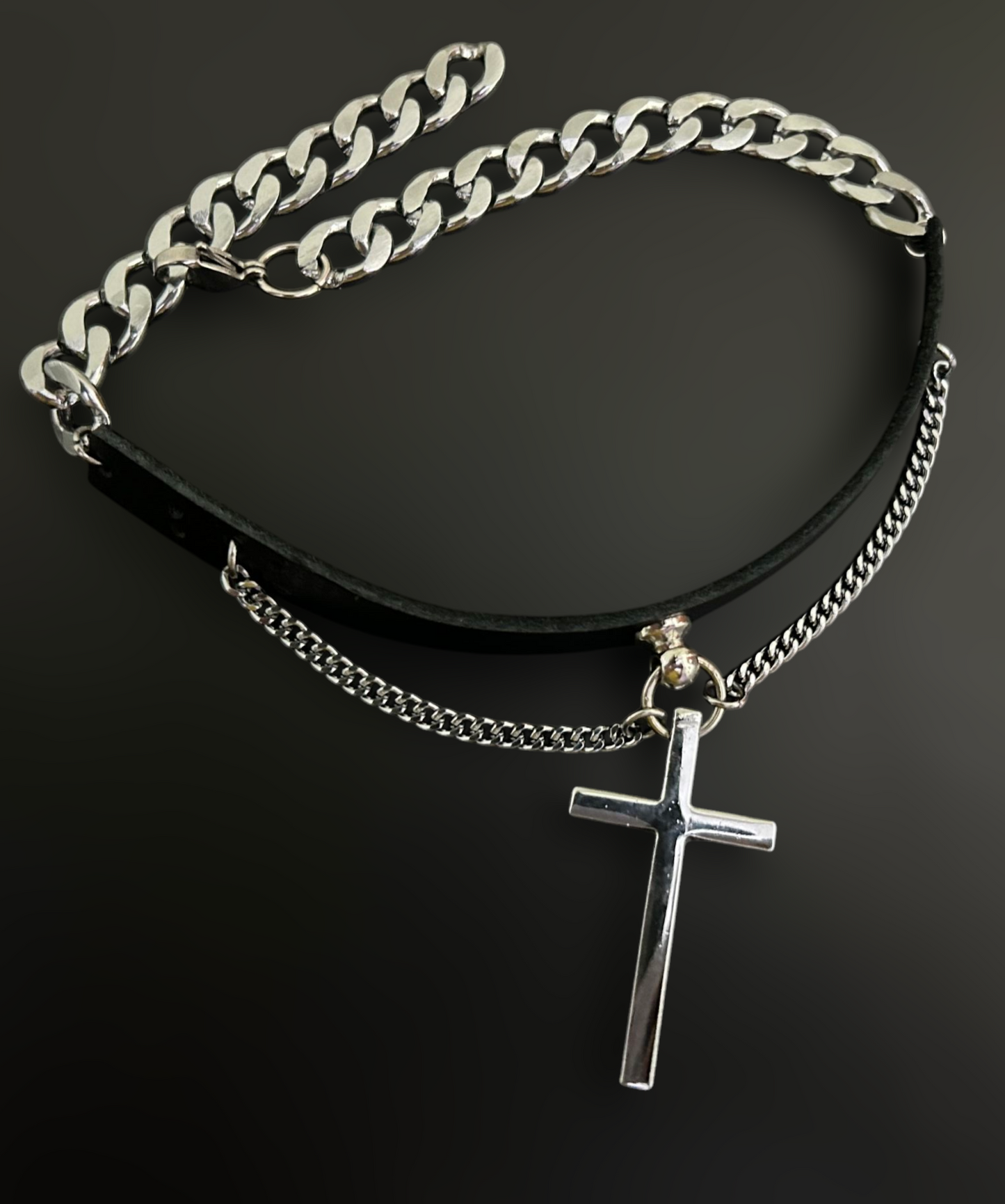 Flat lay of gothic leather collar choker with cross pendant. Unisex stainless steel jewelry and alt fashion accessories by Phantom Cat. Inspired by gothic themes in the Netflix Miniseries 'Midnight Mass.'