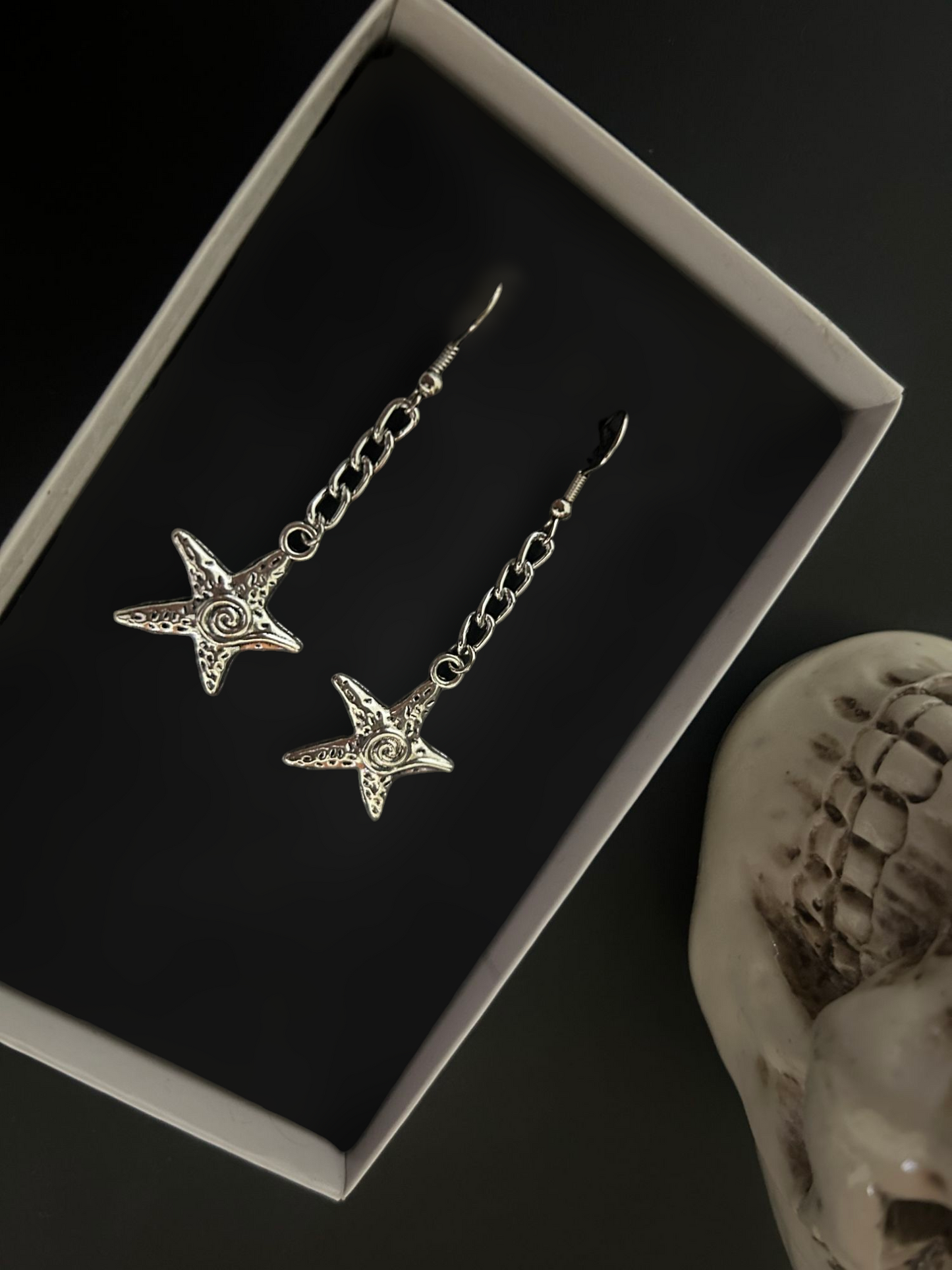 Top view of star dangle earrings on curb chain — Alt and gothic jewelry online Shop in India, celestial gothic earrings for y2k, kpop, cosplay and fantasy styling.