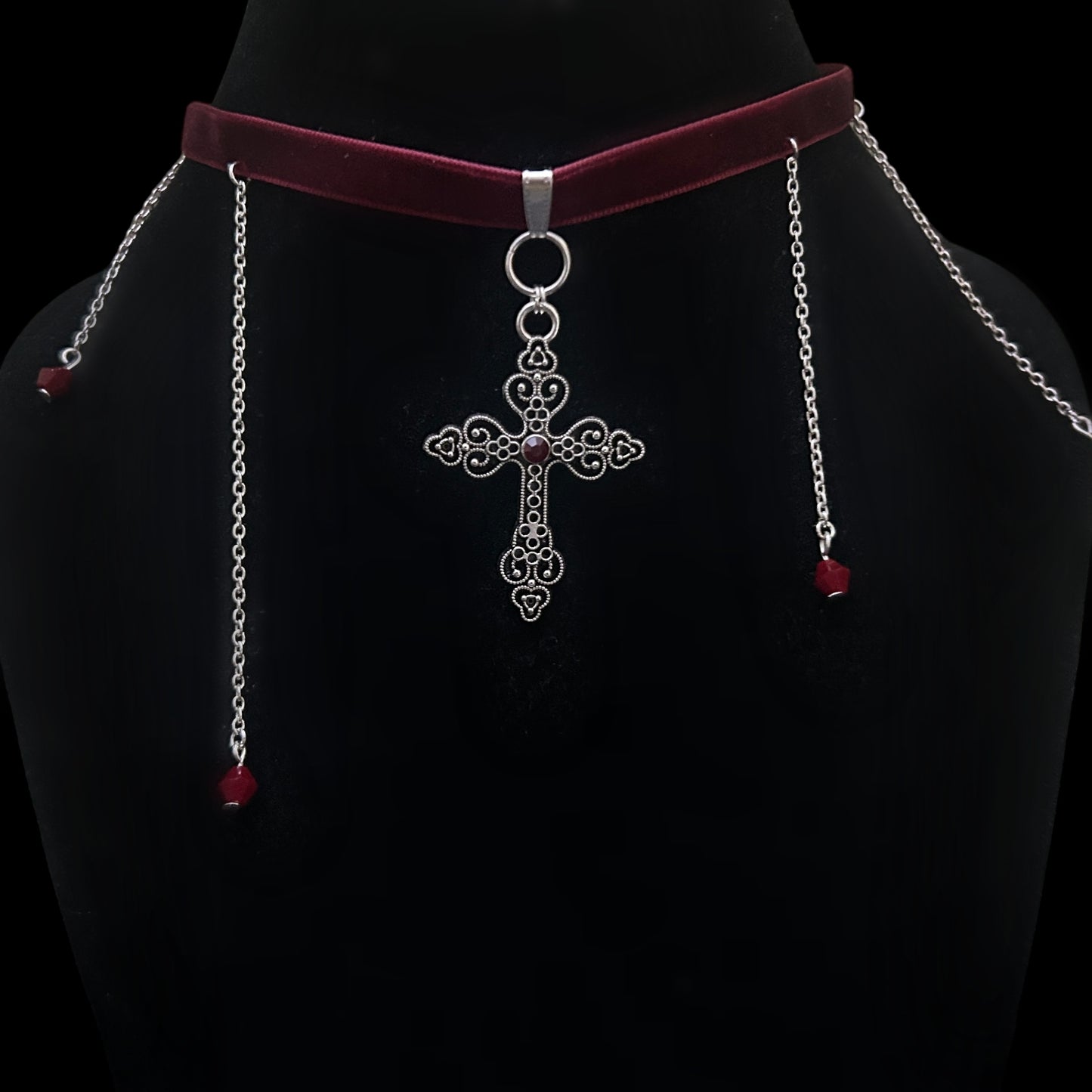 Gothic velvet choker with intricate silver cross pendant and red beaded chain drops on black mannequin – gothic, grunge, alt fashion jewelry