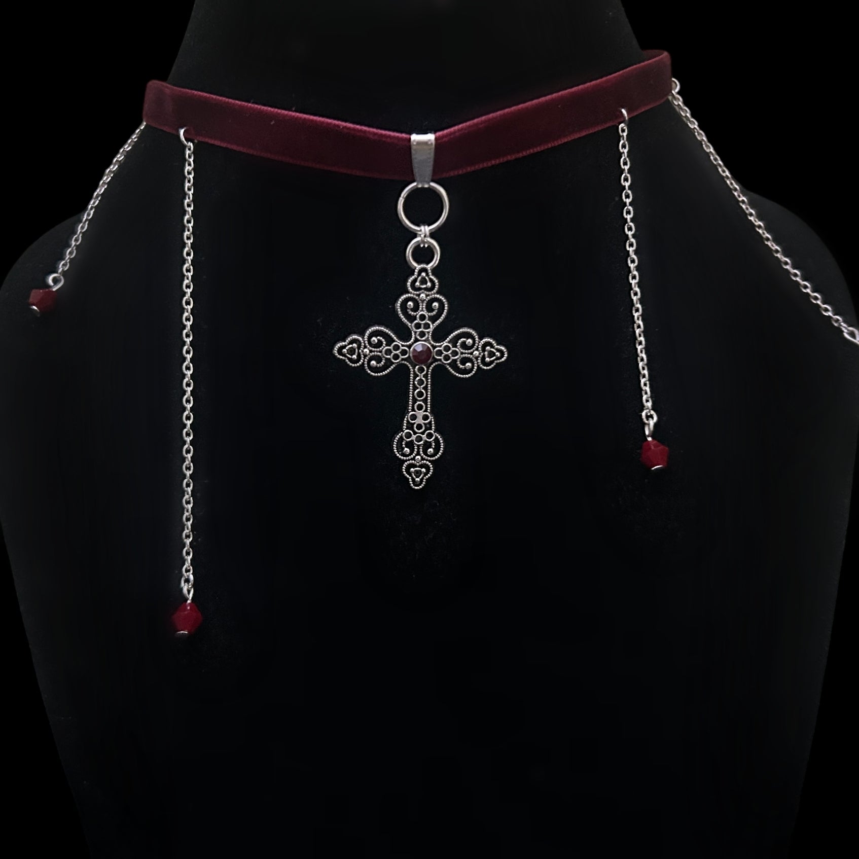 Gothic velvet choker with intricate silver cross pendant and red beaded chain drops on black mannequin – gothic, grunge, alt fashion jewelry