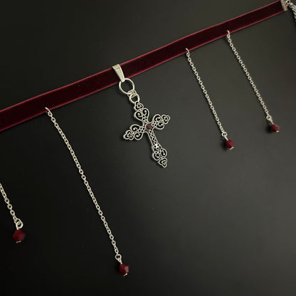 Flatlay of maroon velvet gothic choker with detailed silver cross and hanging chain accents – gothic jewelry, fantasy style, y2k alternative look