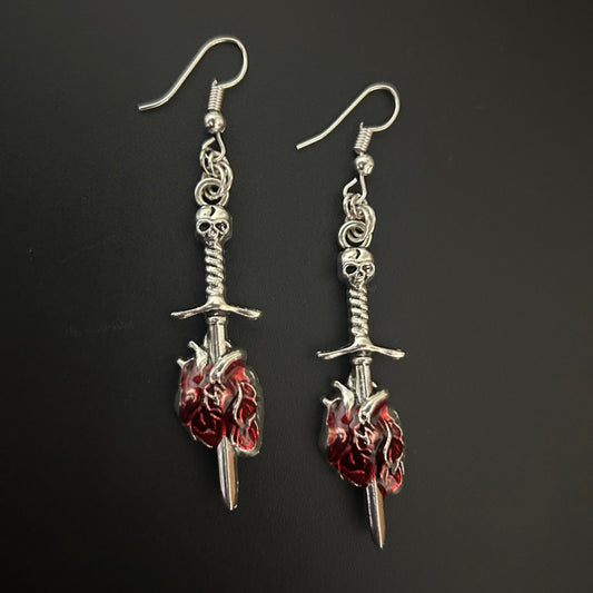 Skull Dagger Earrings piercing anatomical heart motifs. Shop gothic style earrings at affordable rates online in India - perfect for punk, rockstar and alt wardrobes