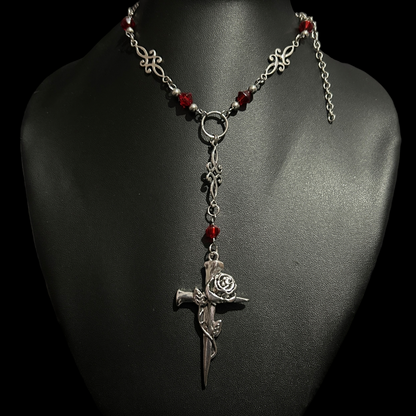 Front view of Phantom Cat India's Blood and Roses Cross Necklace -Y-drop cross pendant with a rose detail. Gothic fashion jewelry ideal for grunge, alt-core, and dark romantic styling.