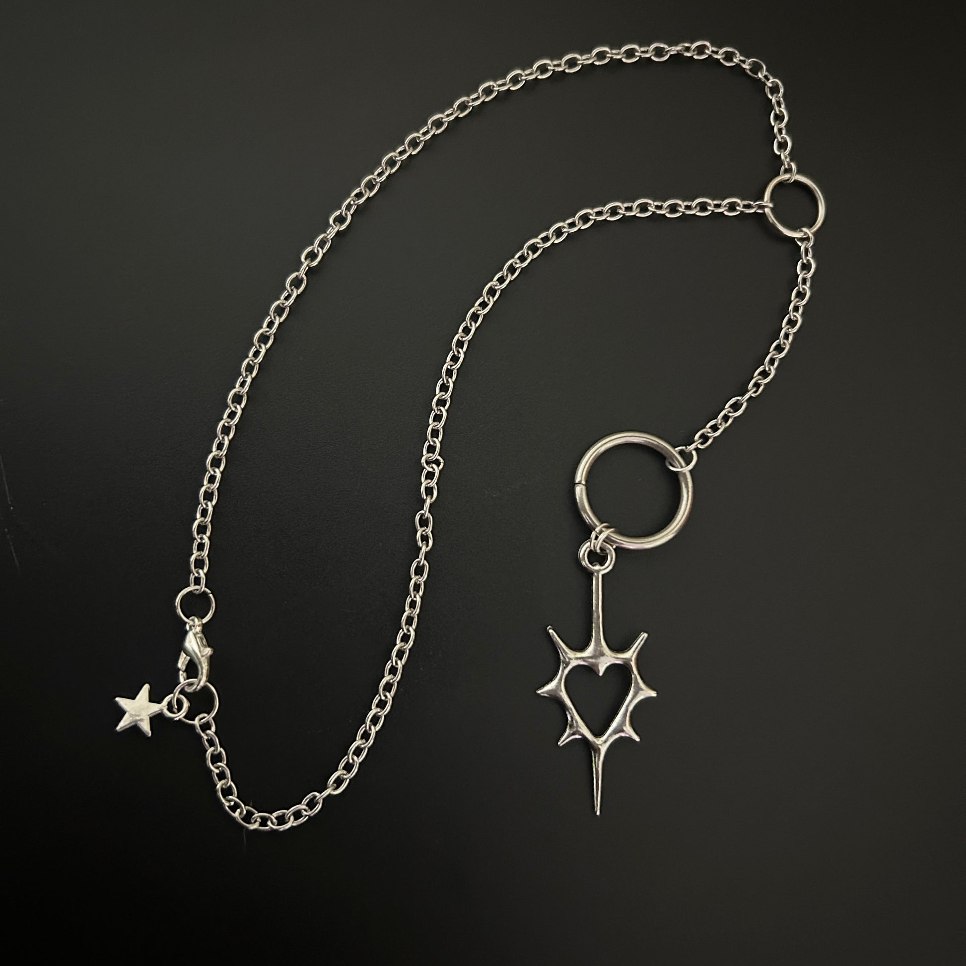 Close-up of gothic necklace with a spike heart pendant. Shop grunge fashion accessories in India - perfect for alt, street style and cosplay. 