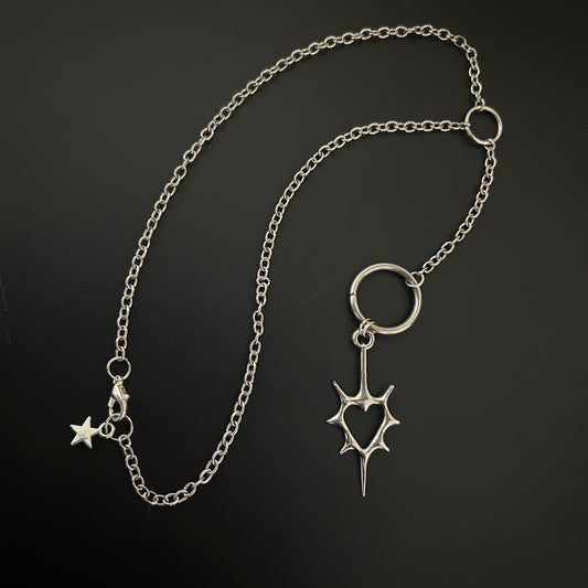 Close-up of gothic necklace with a spike heart pendant. Shop grunge fashion accessories in India - perfect for alt, street style and cosplay. 