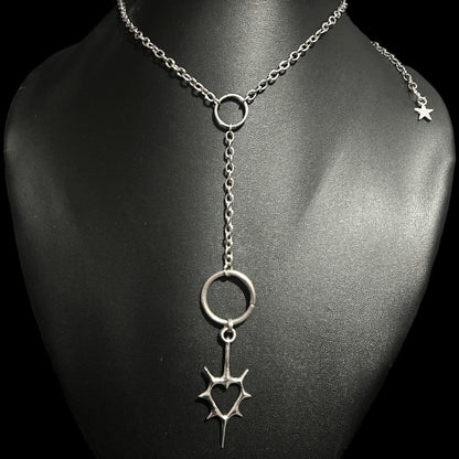 Gothic heart Y-necklace styled on a black mannequin feat. spiked heart charm. Grunge jewelry piece for alt-core, anime cosplay looks, and K-pop fashion aesthetics in India