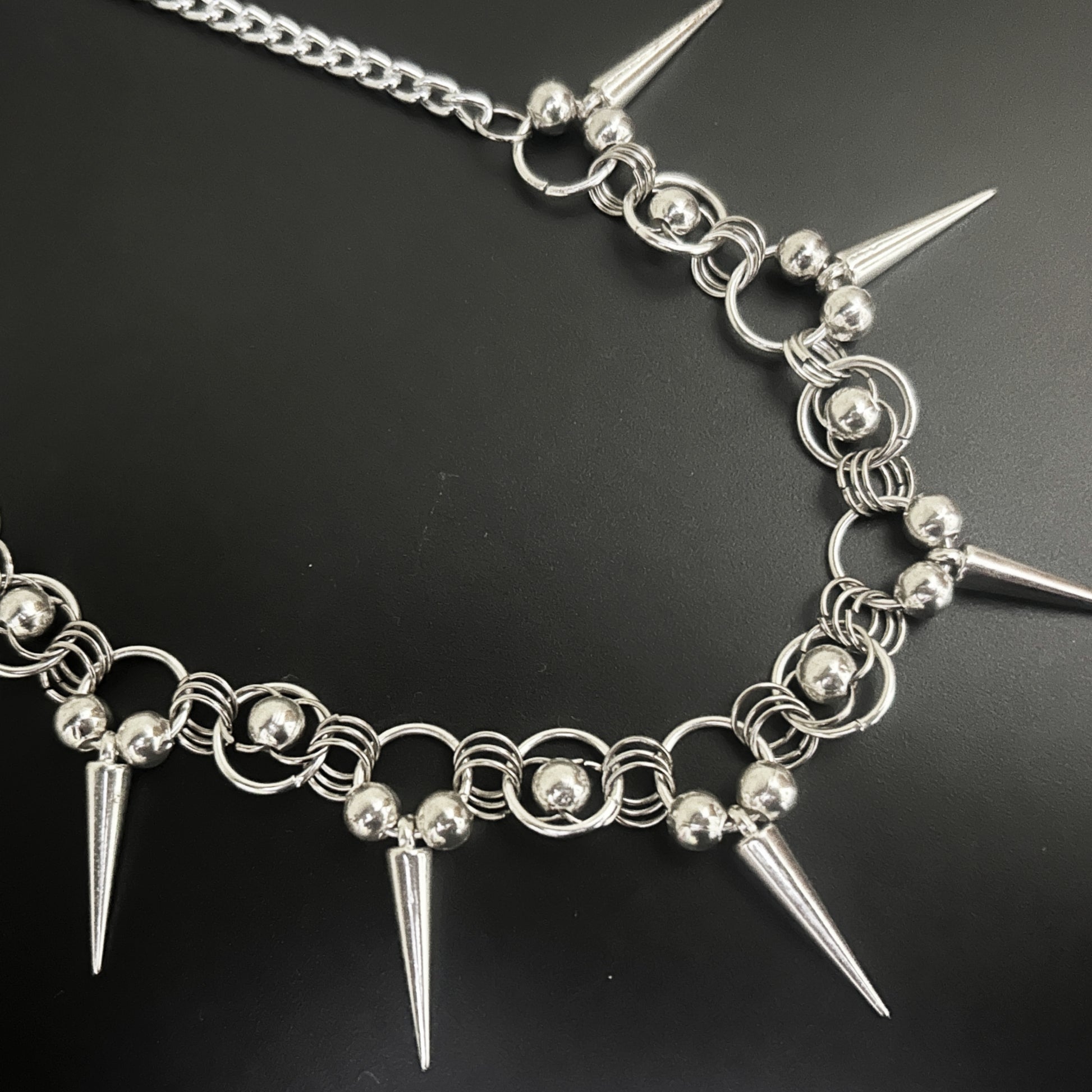 Front view of Iron Thorn Chainmaille Choker by Phantom Cat India feat. silver spikes and bead-ring clusters. Gothic and alt fashion jewelry with chainmaille construction and punk-inspired design.