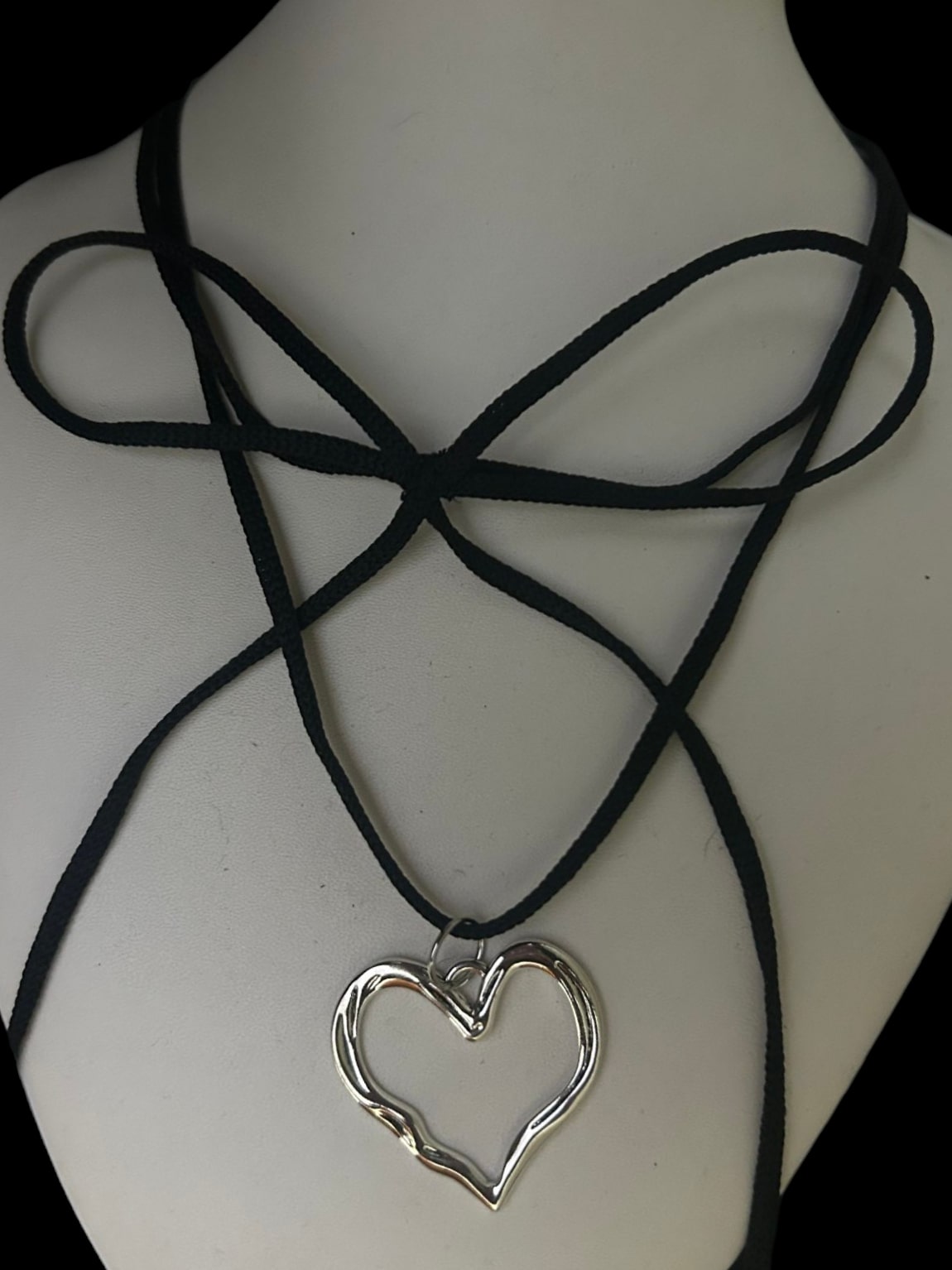 Front view of grunge heart choker with a bow design. Lightweight alt tarnish resistant accessory. Perfect for anime cosplay, alt, y2k and grunge fashion enthusiasts.  
