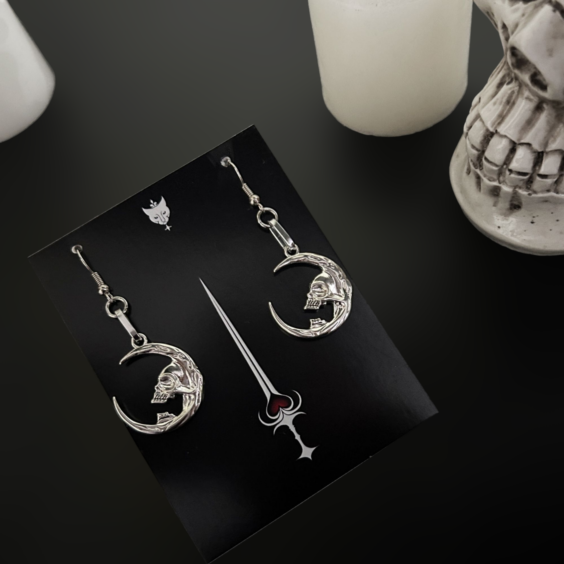 Silver moon skull earrings styled for gothic, occult, and fantasy fashion. Vampire-core jewelry for dark alt wardrobes. Shop accessories online in India.