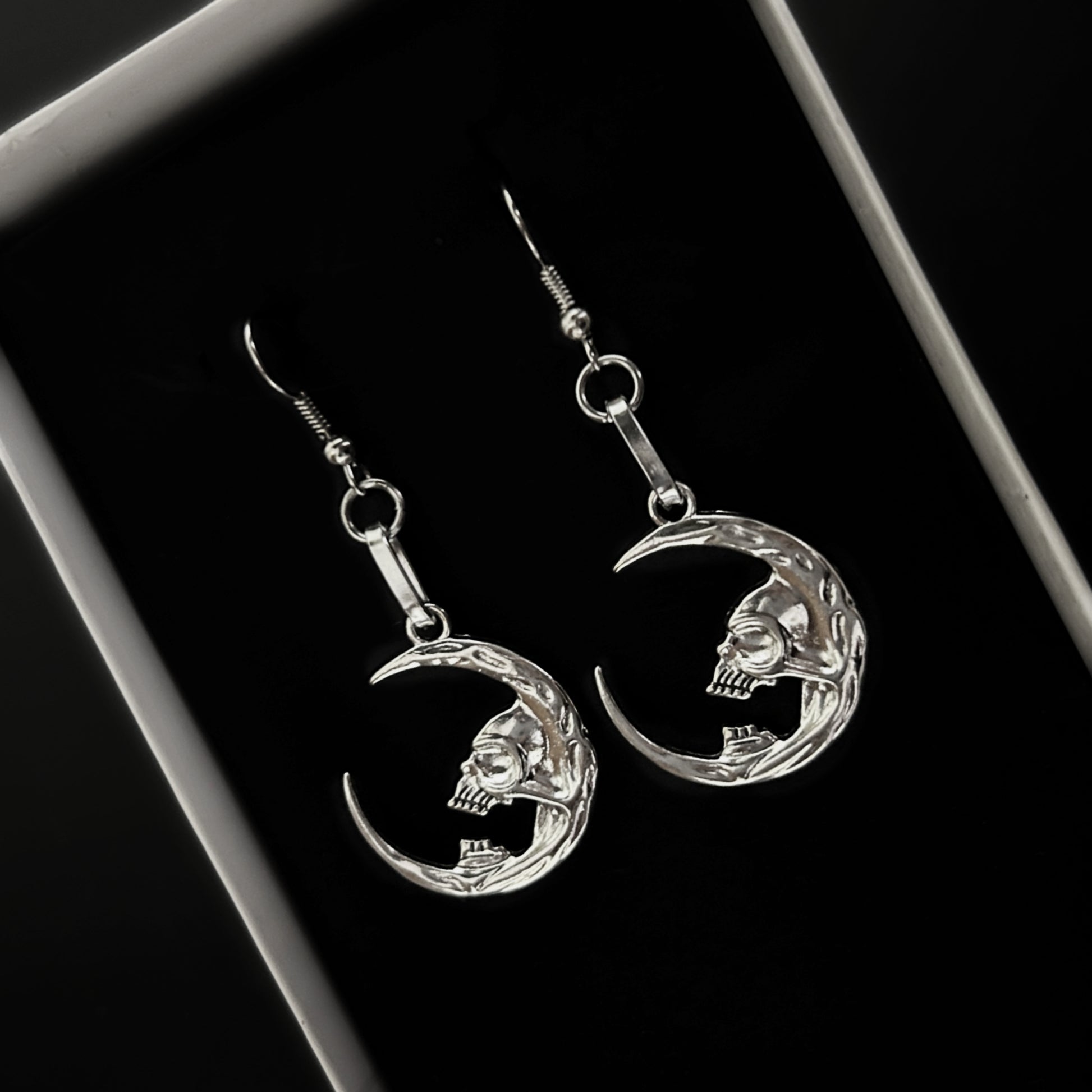 Crescent moon earrings with skull design for gothic and death-themed alt fashion. Dark fantasy jewelry by Phantom Cat. Grunge and vampire aesthetics India.