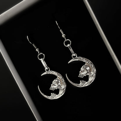 Crescent moon earrings with skull design for gothic and death-themed alt fashion. Dark fantasy jewelry by Phantom Cat. Grunge and vampire aesthetics India.