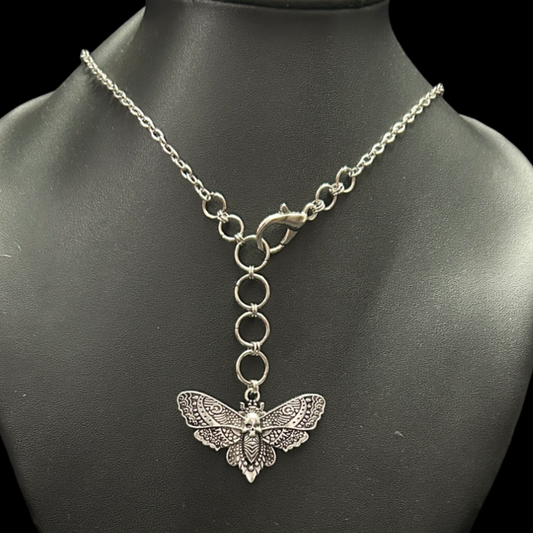 Skull moth gothic choker displayed on a bust with a drop chain detail. Shop gothic necklaces for alt, street style, and dark fashion aesthetics in India