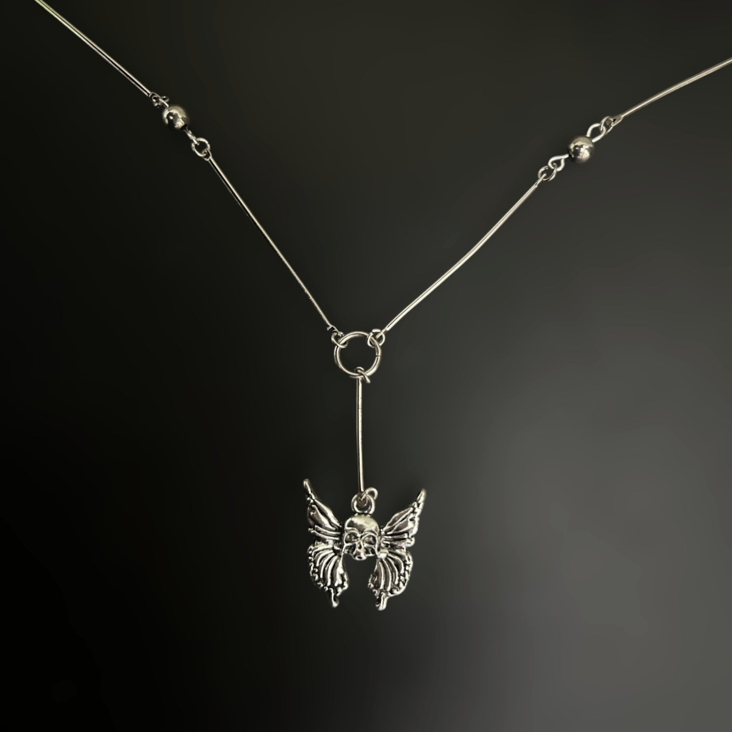 Skull Wing Bones Y Drop Gothic Necklace by Phantom Cat India. Gothic, alt fashion accessory with Y2K and fantasy elements.