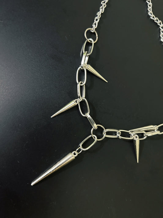 Close-up of gothic spikes necklace with thick, chunky chain. Shop bold grunge fashion accessories for alt and rock-inspired outfits in India.